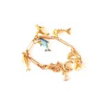 A 9ct gold bracelet with eight charms