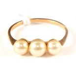 A 9ct gold ring set with three pearls,