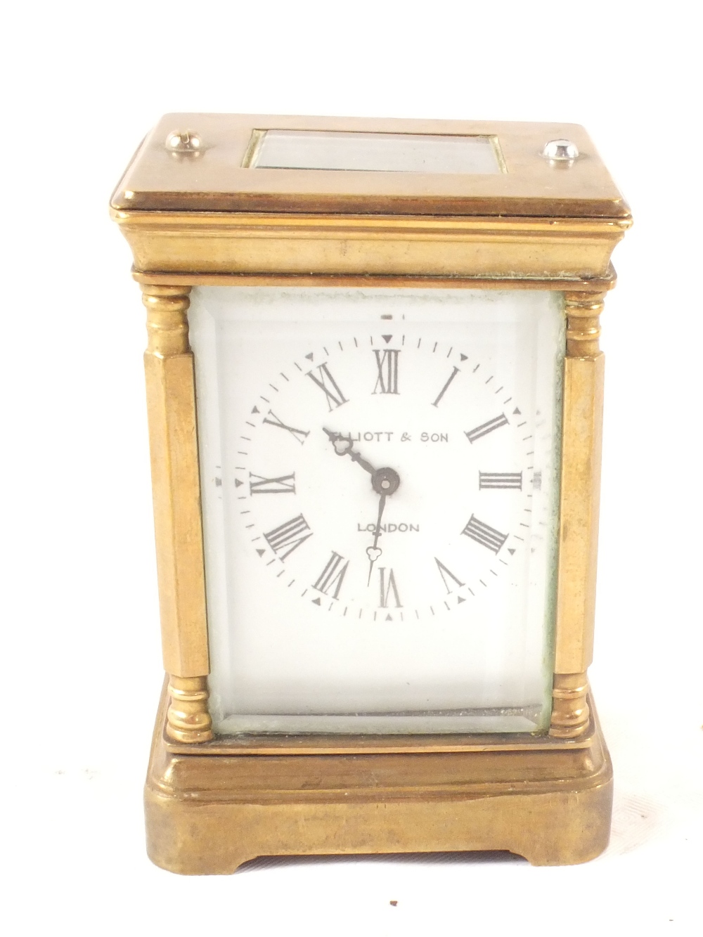 A small brass carriage clock, dial marked Elliott & Son,