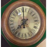 A large circular oak brass dial wall clock