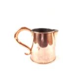 A heavy Georgian seamed copper ale jug of tapering cylindrical form,