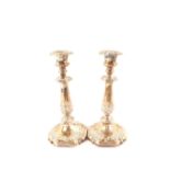 A pair of silver plated on copper candlesticks