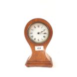 An Edwardian mahogany cased waisted mantel clock