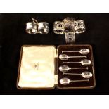 A cased set of six silver coffee spoons plus six serviette rings (four pierced)