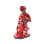 A Royal Doulton Flambe figure 'The Lamp Seller'