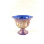 A blue glass bowl with painted and gilt decoration of medieval horses, riders and nude bathers,