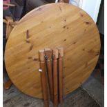 An extending circular pine kitchen table with built in extra leaf