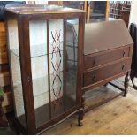 A 1950's glazed china display cabinet with glass shelves and a modern two drawer bureau on turned