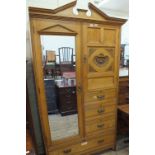 An Edwardian compactum wardrobe with carved decoration