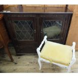 An Old Charm style astral glazed cupboard and a white painted piano stool