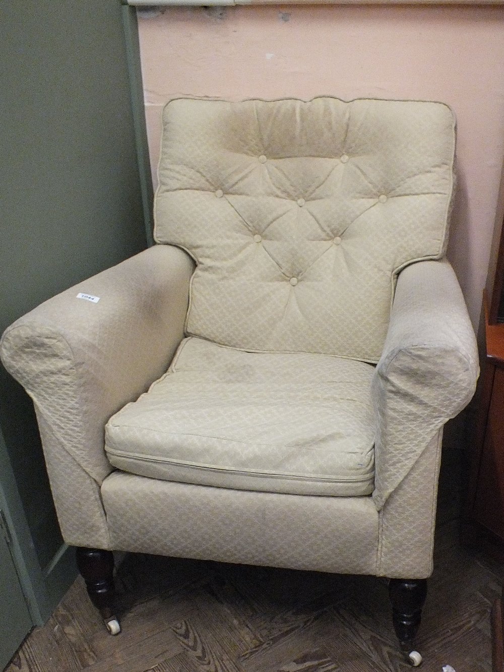 A cream upholstered armchair
