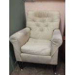 A cream upholstered armchair