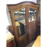 An elegant French two mirrored door armoire with carved column and other carved detail