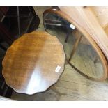 A vintage sewing box on legs and an oval wall mirror