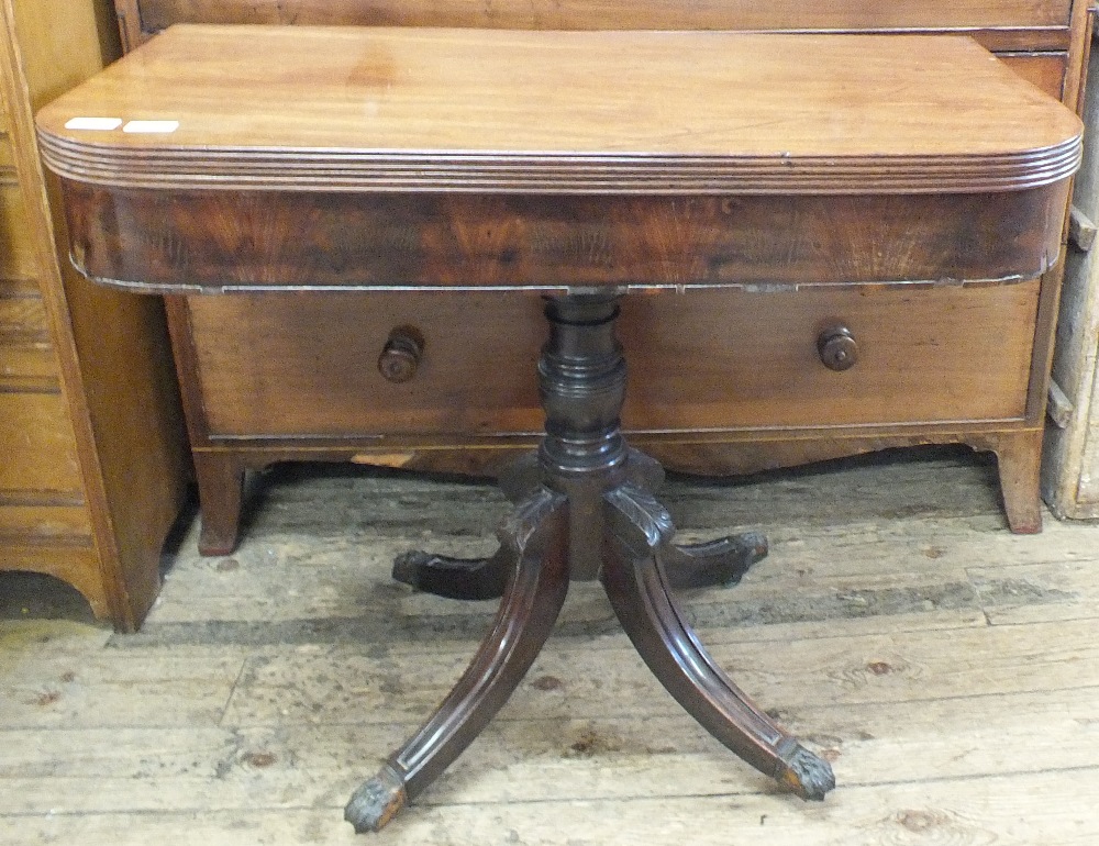 A 19th Century mahogany lift top serving table on quatrefoil base