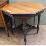 An Edwardian octagonal occasional table with turned legs and carve frieze under tier