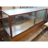 A vintage glass top and front shop display counter