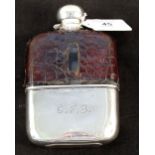 A hip flask with silver fittings and cup,