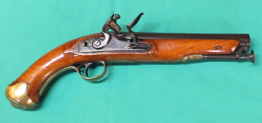 A Flintlock pistol with brass furniture and captive ramrod, lock with border line engraving,