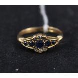 An 18ct gold sapphire and white stone ring,