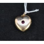 A yellow metal heart shaped photo locket set with red stone inscribed Ruby to reverse