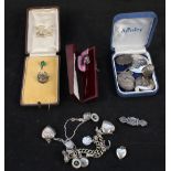 A collection of silver and white metal jewellery including charm bracelet, heart shaped lockets,