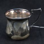 A silver christening mug with initials,