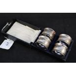 A set of four napkin rings with engine turned decoration in a box