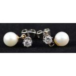 A pair of white metal diamond stud earrings with pearl drops