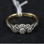 An 18ct gold ring with three illusion set diamonds,