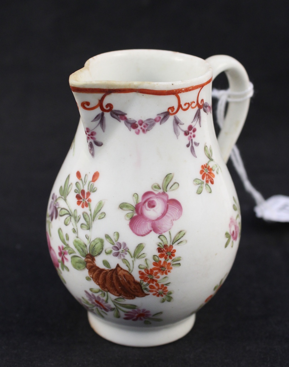 A Lowestoft Curtis pattern polychrome sparrow beak jug with seashell decoration (crack to lower