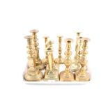 Five pairs of Georgian and Victorian brass candlesticks,