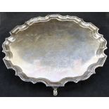 A silver shaped edge salver with presentation inscription,