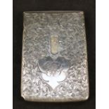 An unusual silver card case with engraved leaf decoration, sliding action to release cards,