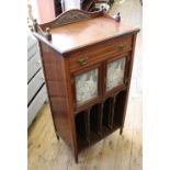 An Edwardian two door glazed music cabinet