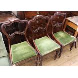 Four Victorian carved mahogany dining chairs