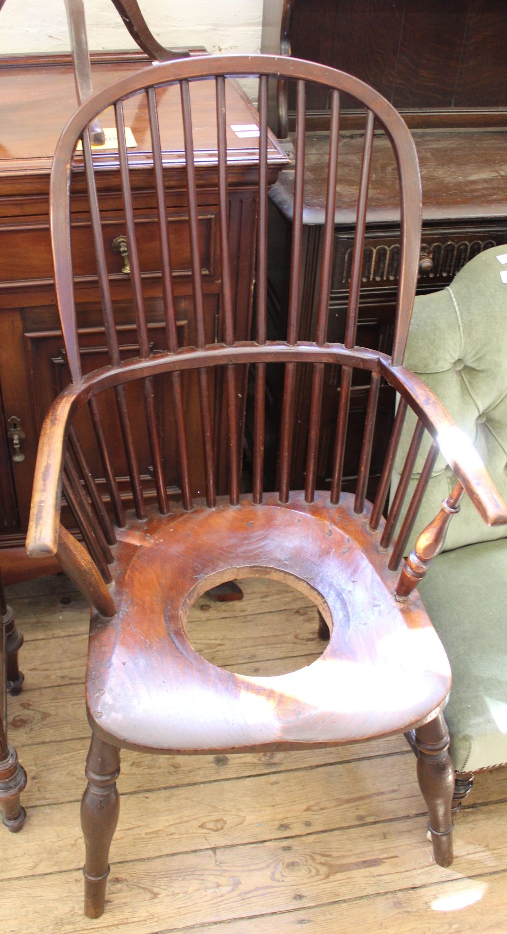 A Victorian comb back elbow chair converted to commode