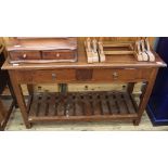 A reproduction two drawer pine serving table with under tier