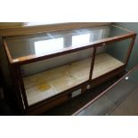 A vintage glass top and front shop display counter