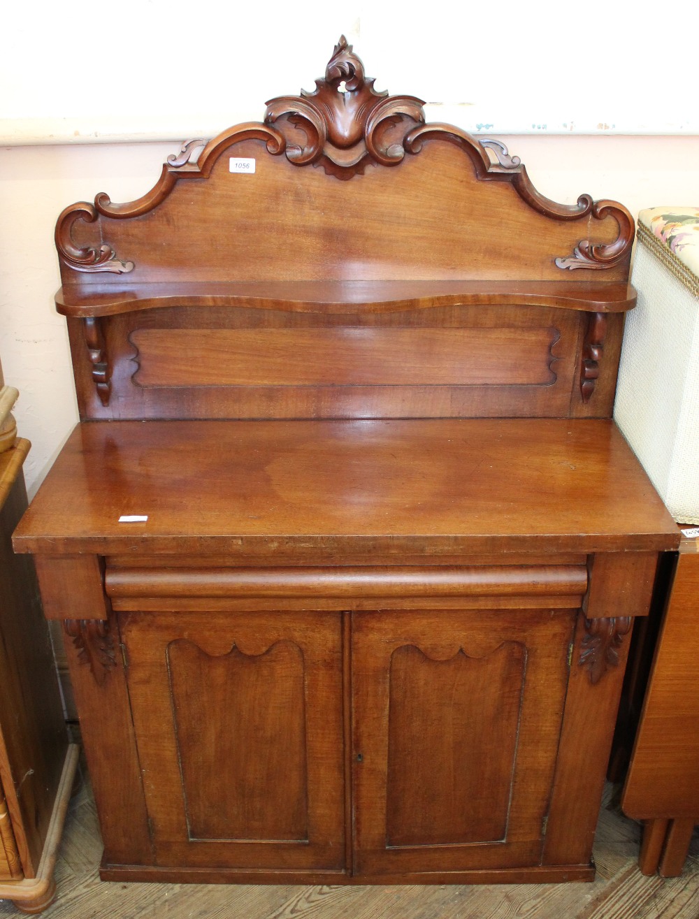 A Victorian mahogany chiffoniere with ornately carved shelf back