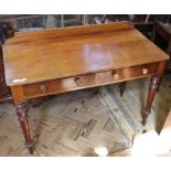 A Victorian two drawer writing desk with upstand