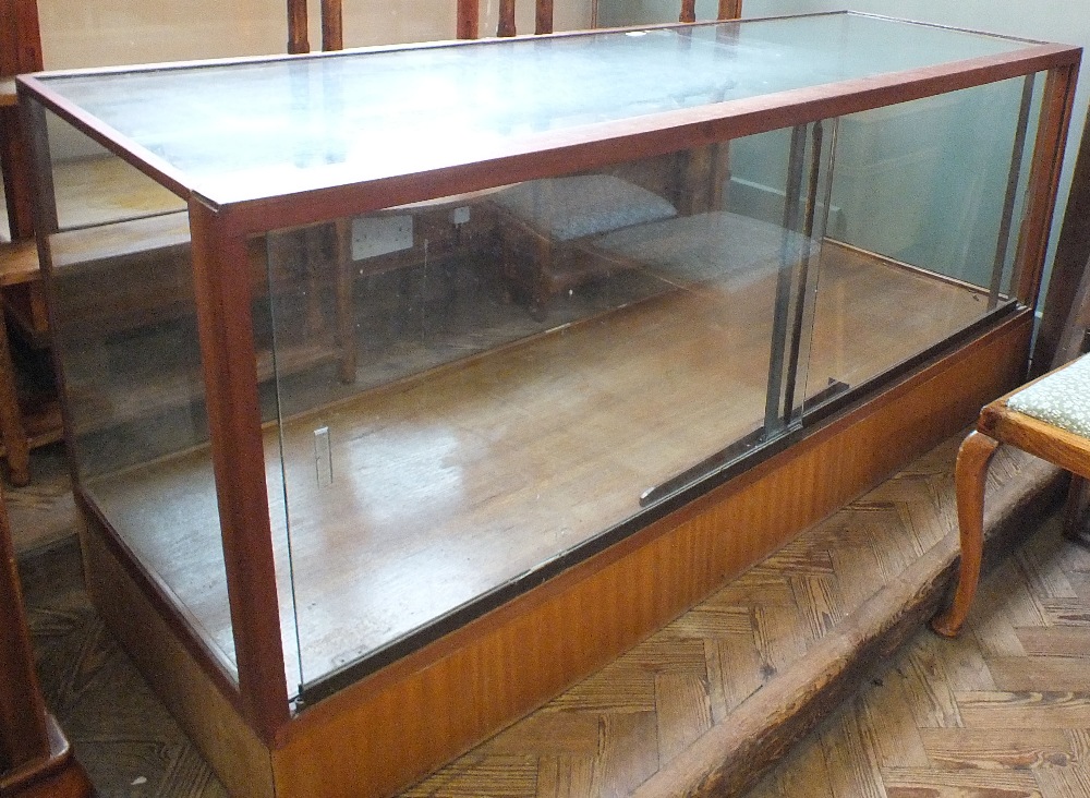 A vintage glass top and front shop display counter