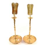 A pair of oriental brass candle prickets with reflectors,