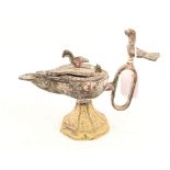 A metal Roman style oil lamp