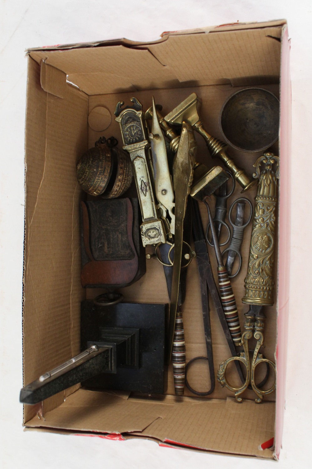 A boxed lot of various metal ware to include 19th Century brass candle snuffers etc