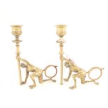 A pair of brass novelty candlesticks with pan supports,