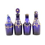 Four early 19th Century Bristol Blue and gilt glass condiment bottles