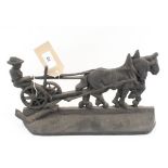 An iron ploughman door stop