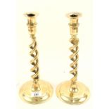 A pair of Edwardian open barley twist brass candlesticks,