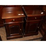 A pair of hardwood bedside tables